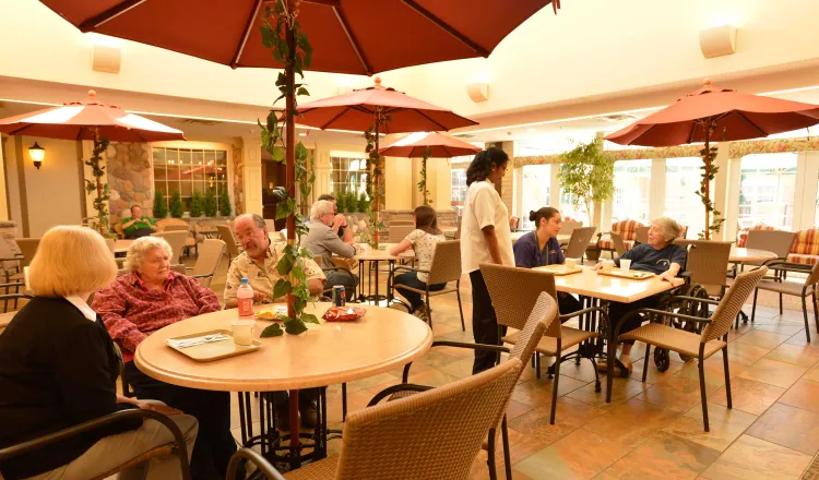 Town Square eatery, tables with umbrella centerpieces in an indoor courtyard