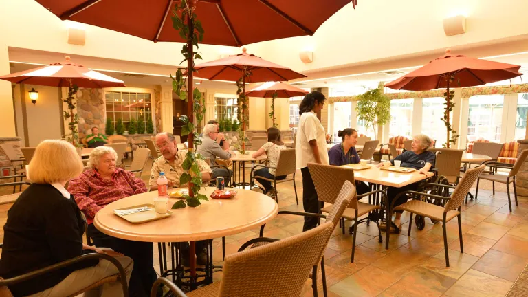 Town Square eatery, tables with umbrella centerpieces in an indoor courtyard