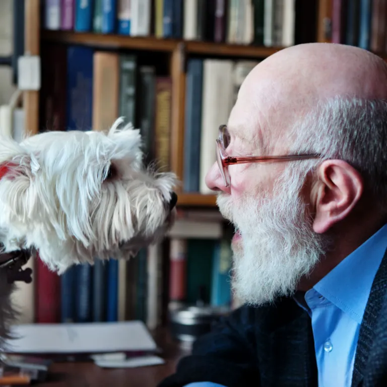 Senior man with small white dog