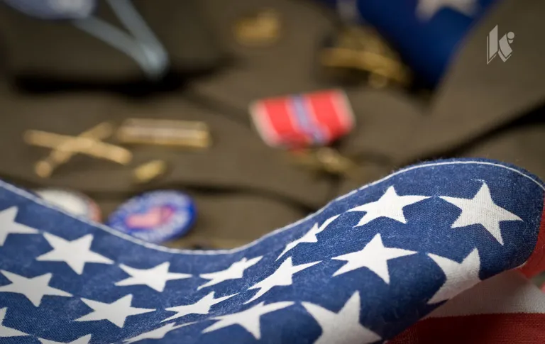 An american flag sits over a veterans uniform