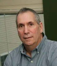 David Merola headshot, he is wearing a light blue button down shirt 